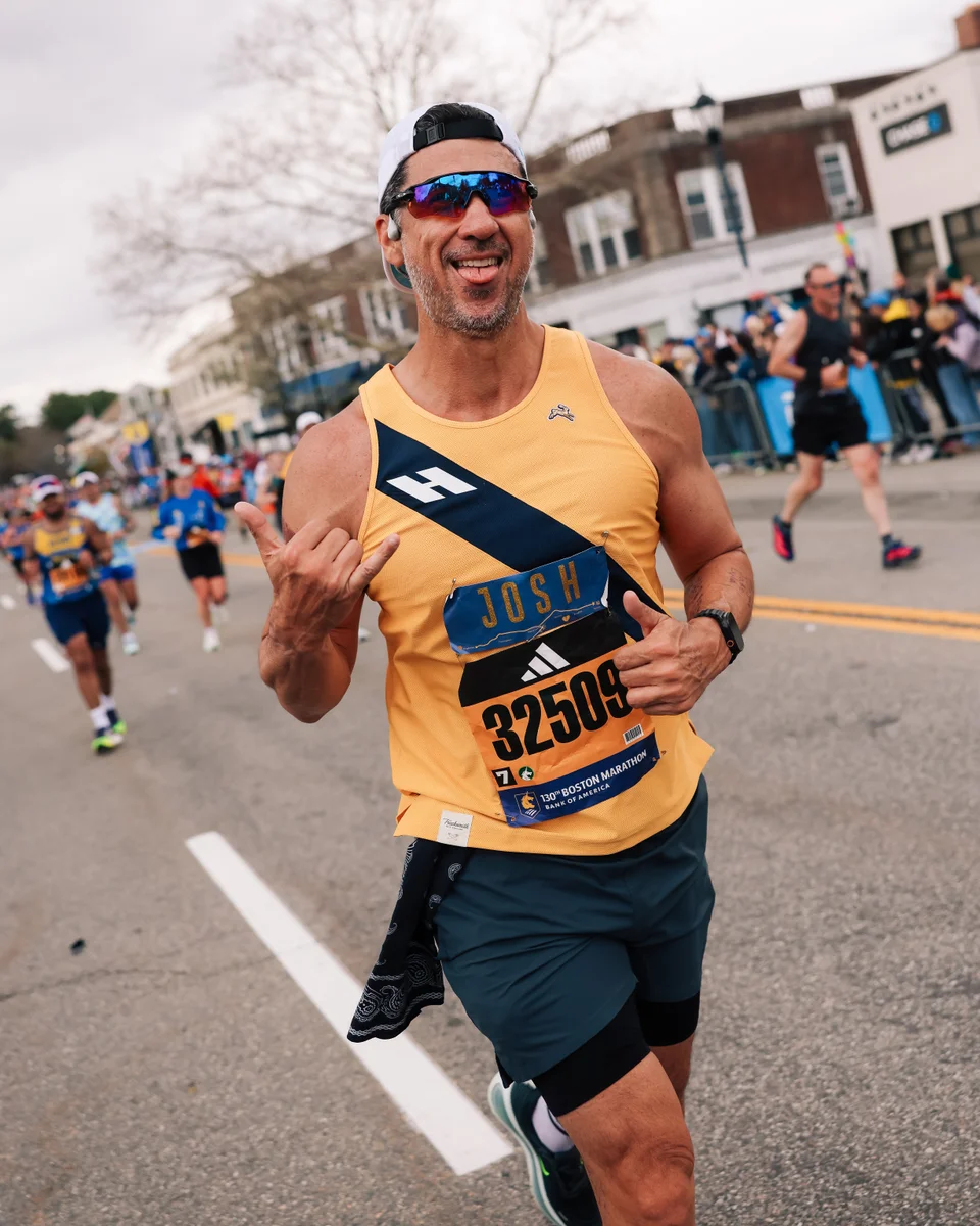 Josh running at Boston in his yellow singlet and bib 32509