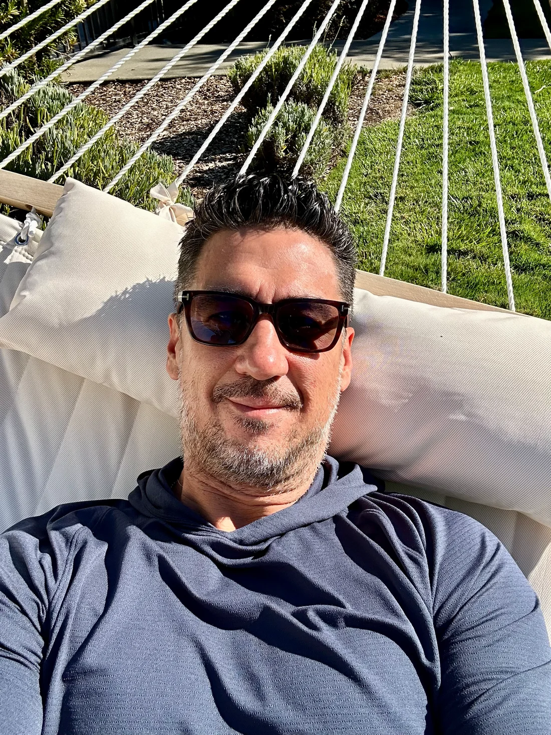 Josh relaxing in a hammock, wearing sunglasses