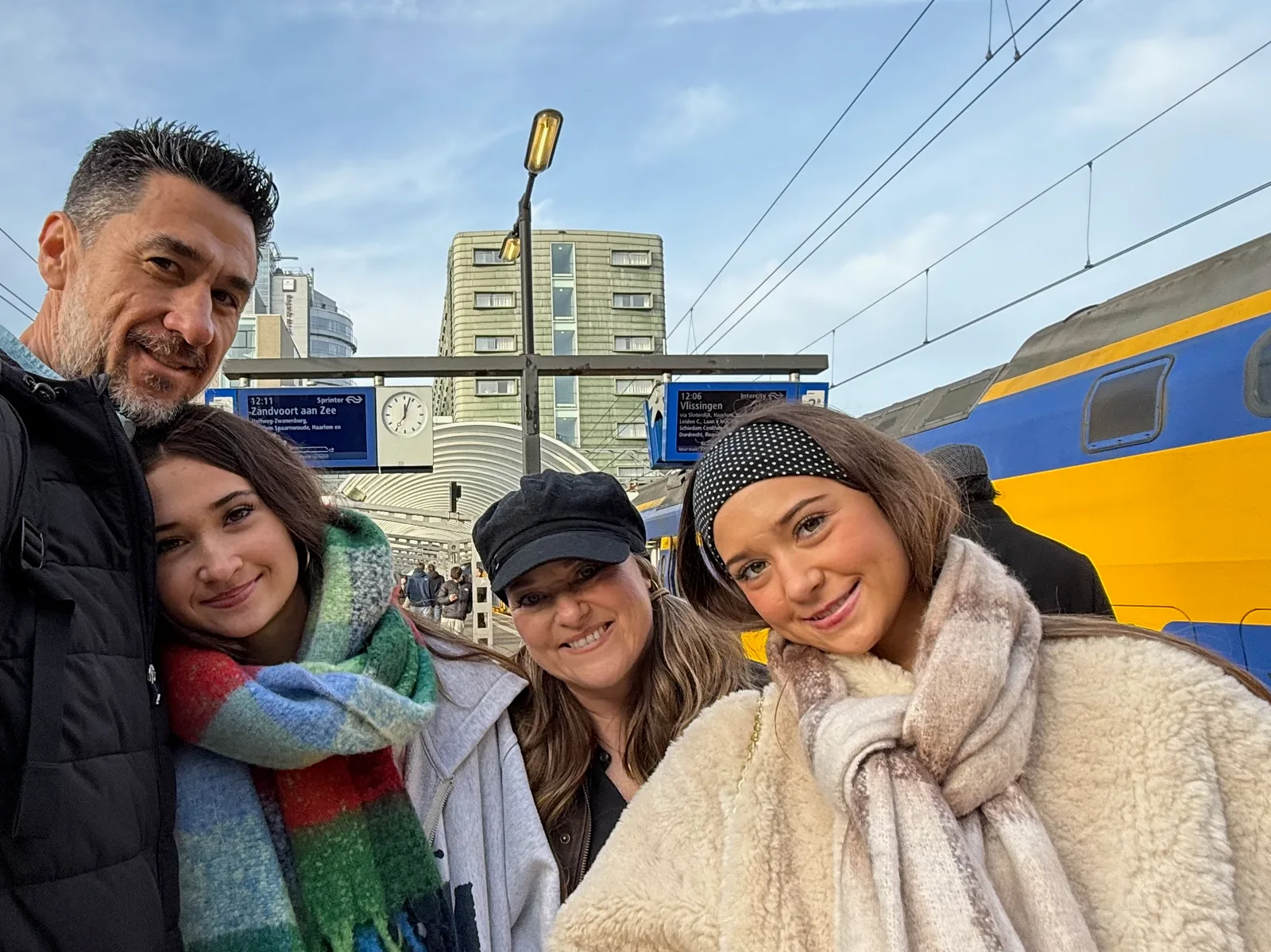 Josh and family at Amsterdam Centraal beside a train