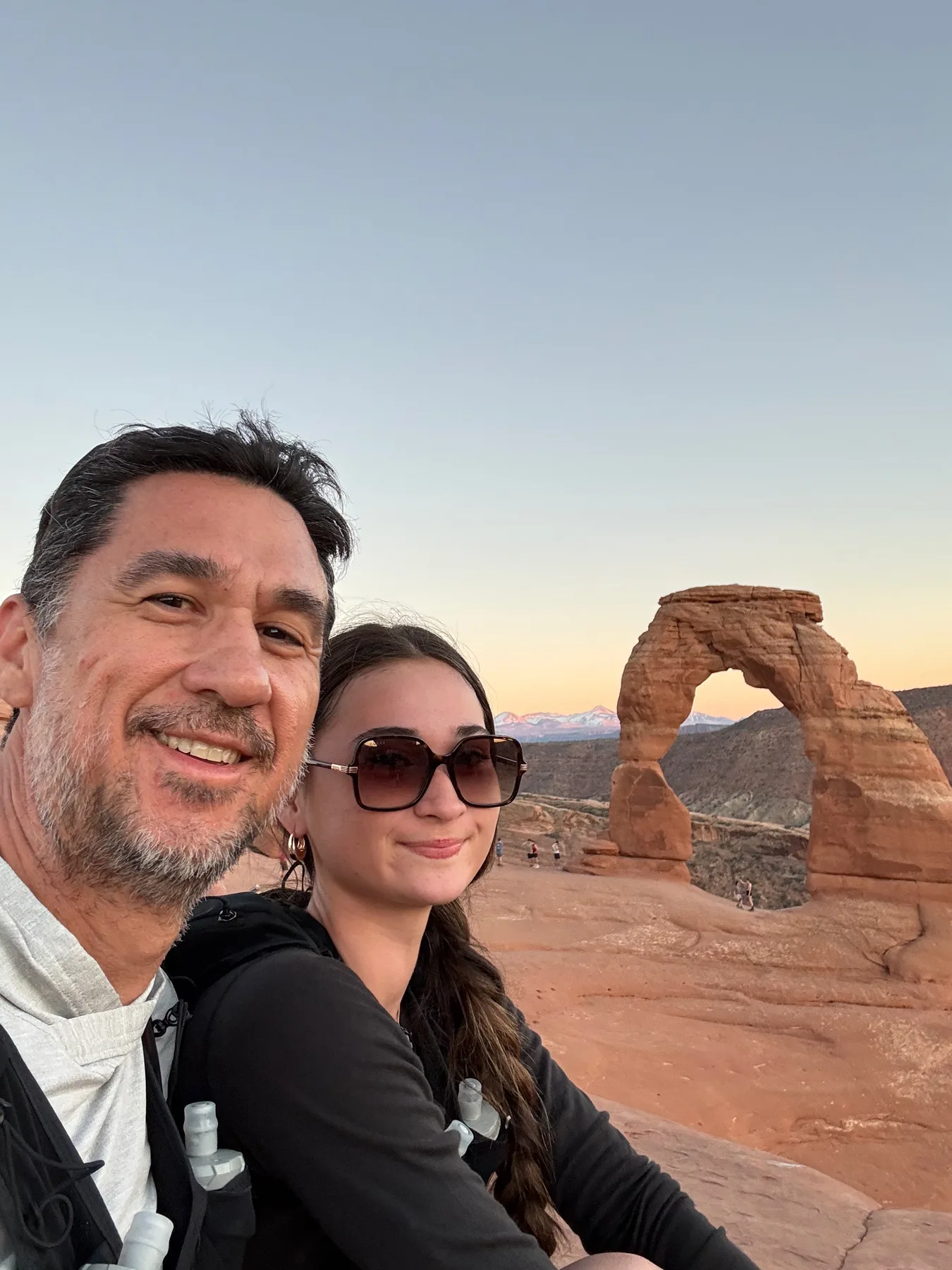 Josh and Lyla at Delicate Arch at sunset