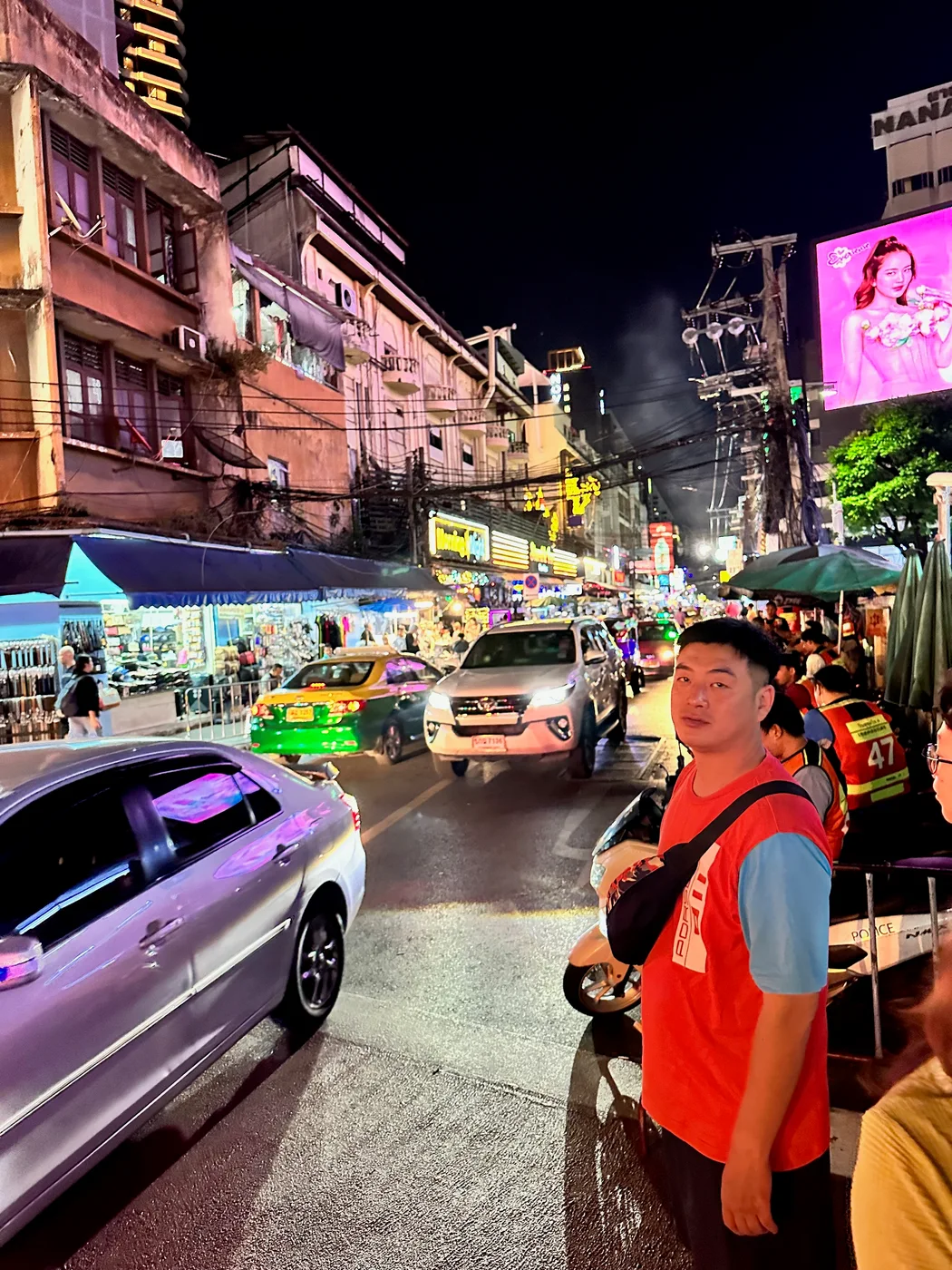 Busy Bangkok street illuminated at night