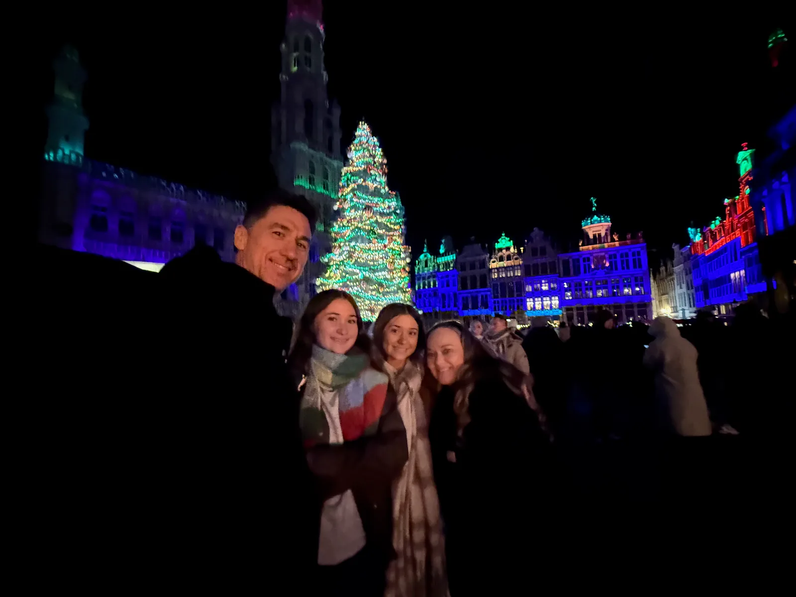 Josh and family beneath the Christmas lights in Grand Place