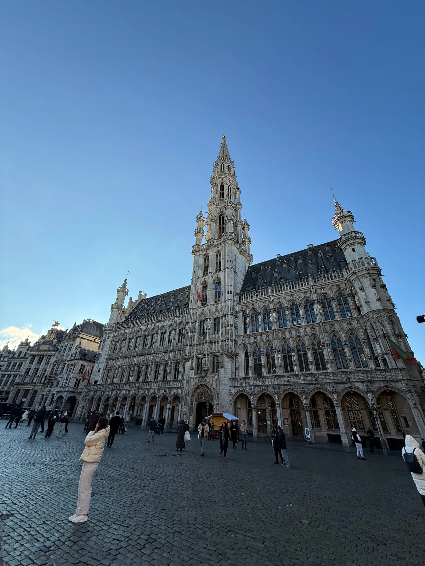 Brussels Town Hall overlooking Grand Place beneath a blue sky