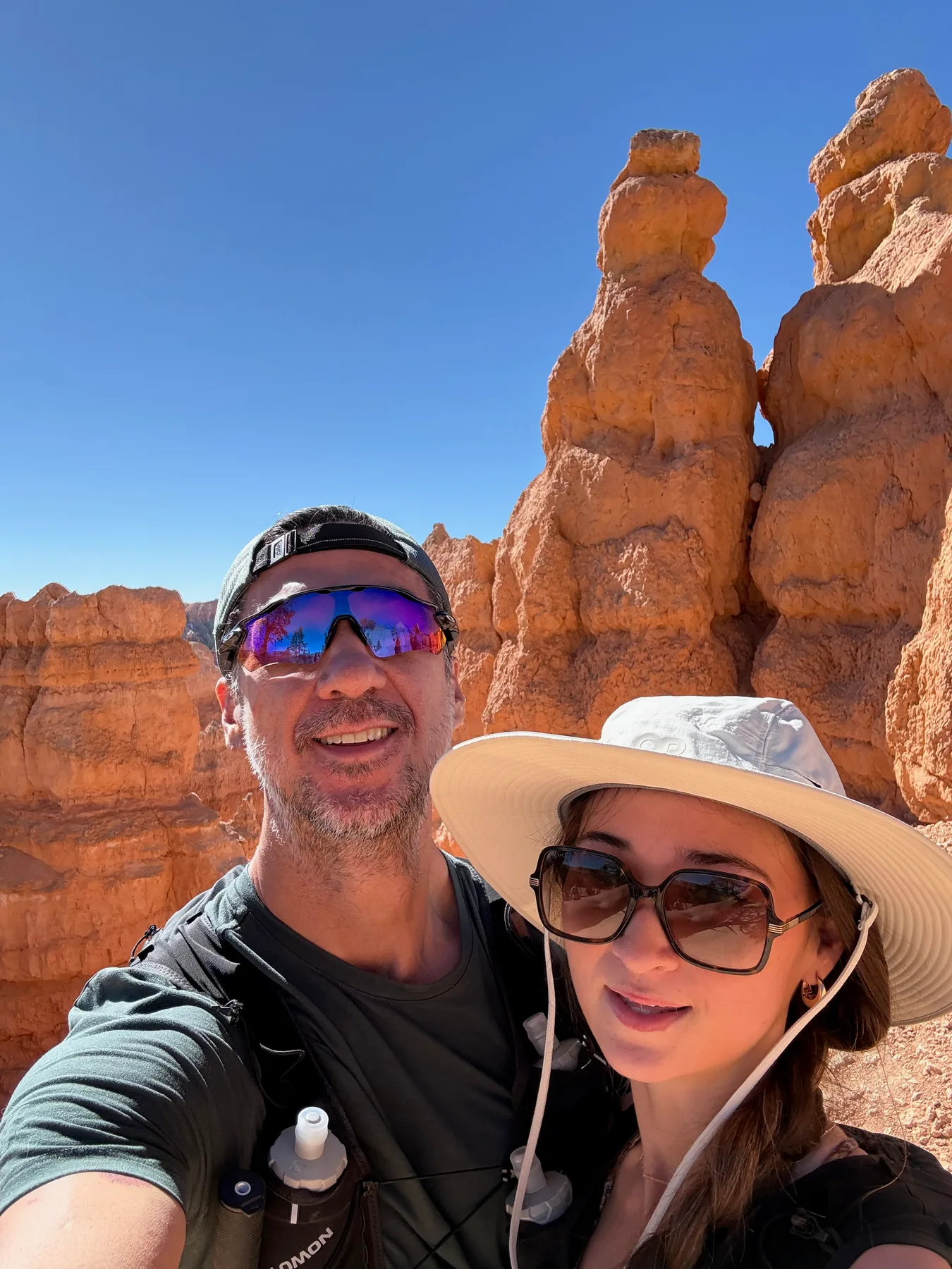 Josh and Lyla together among orange hoodoos in Bryce Canyon