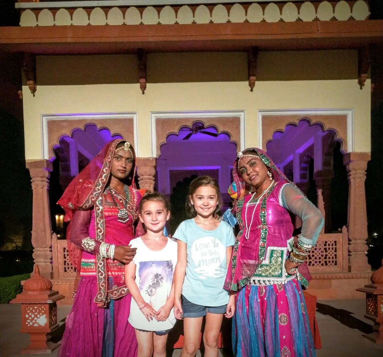 Two sisters with performers in traditional dress