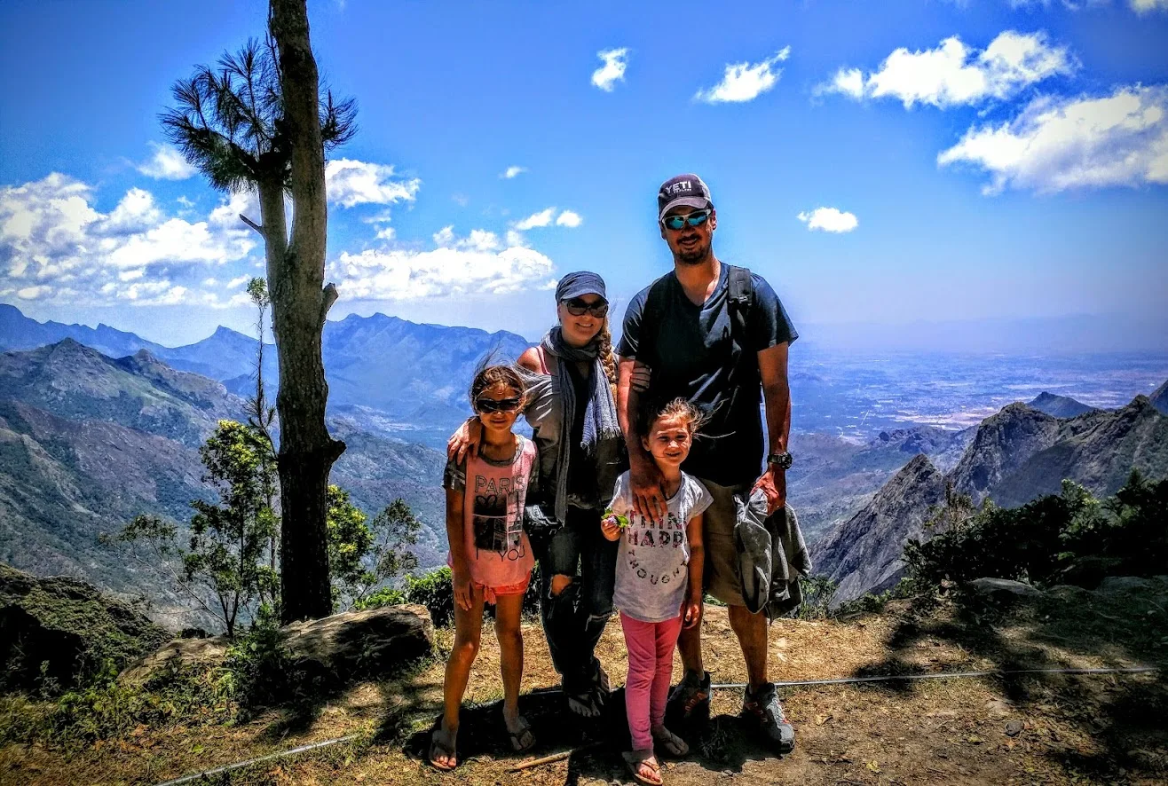 Family of four at a viewpoint in the Kerala hills