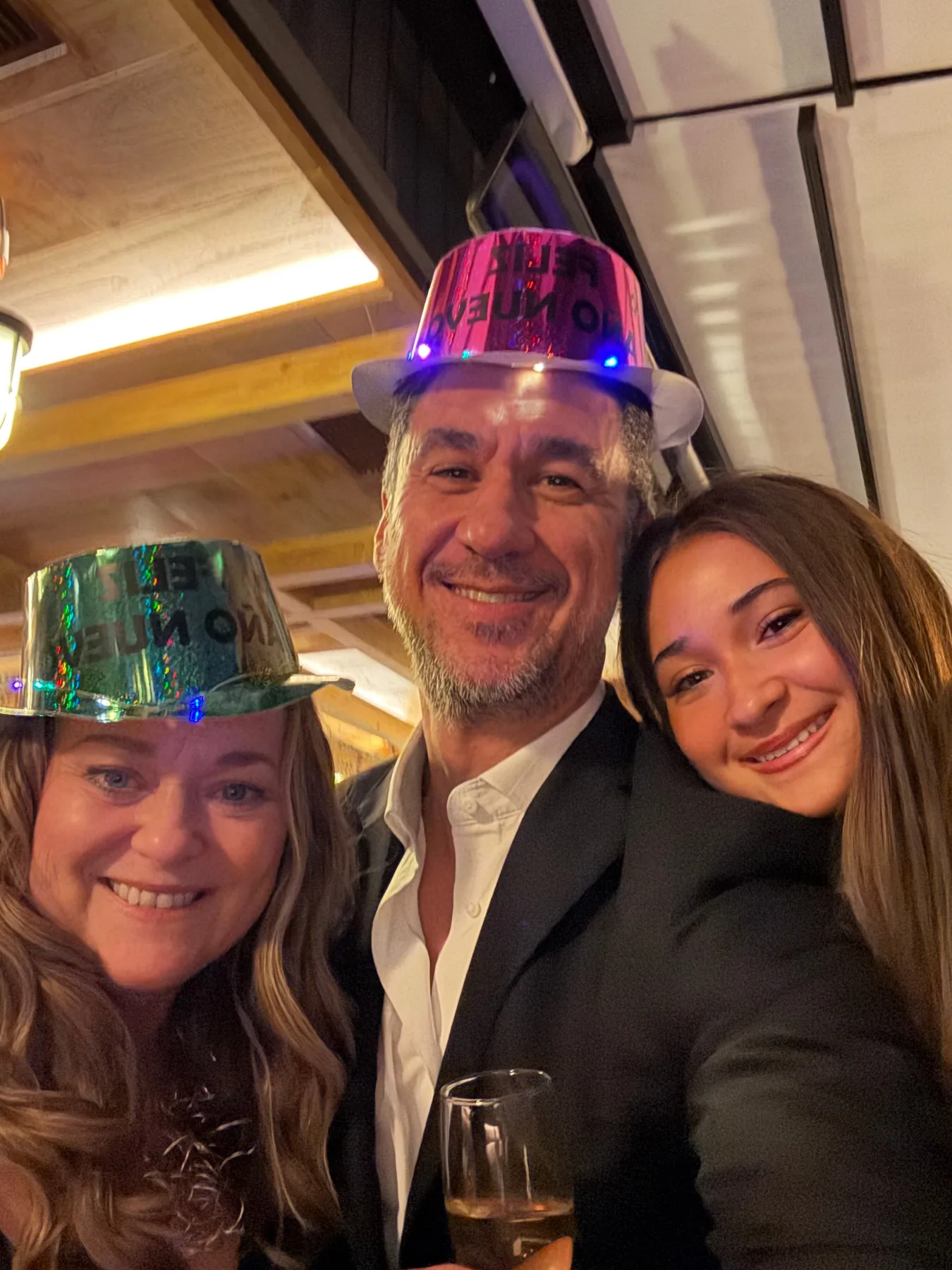 Family selfie wearing festive New Year hats in Madrid