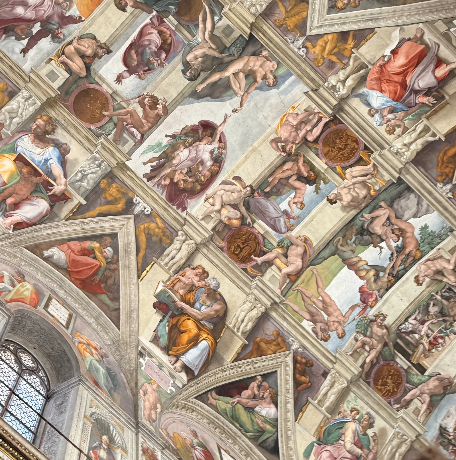 Painted frescoes across the Sistine Chapel ceiling